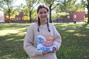 Luna Hansen With Her Book A Kid's Guide To Climate Activism